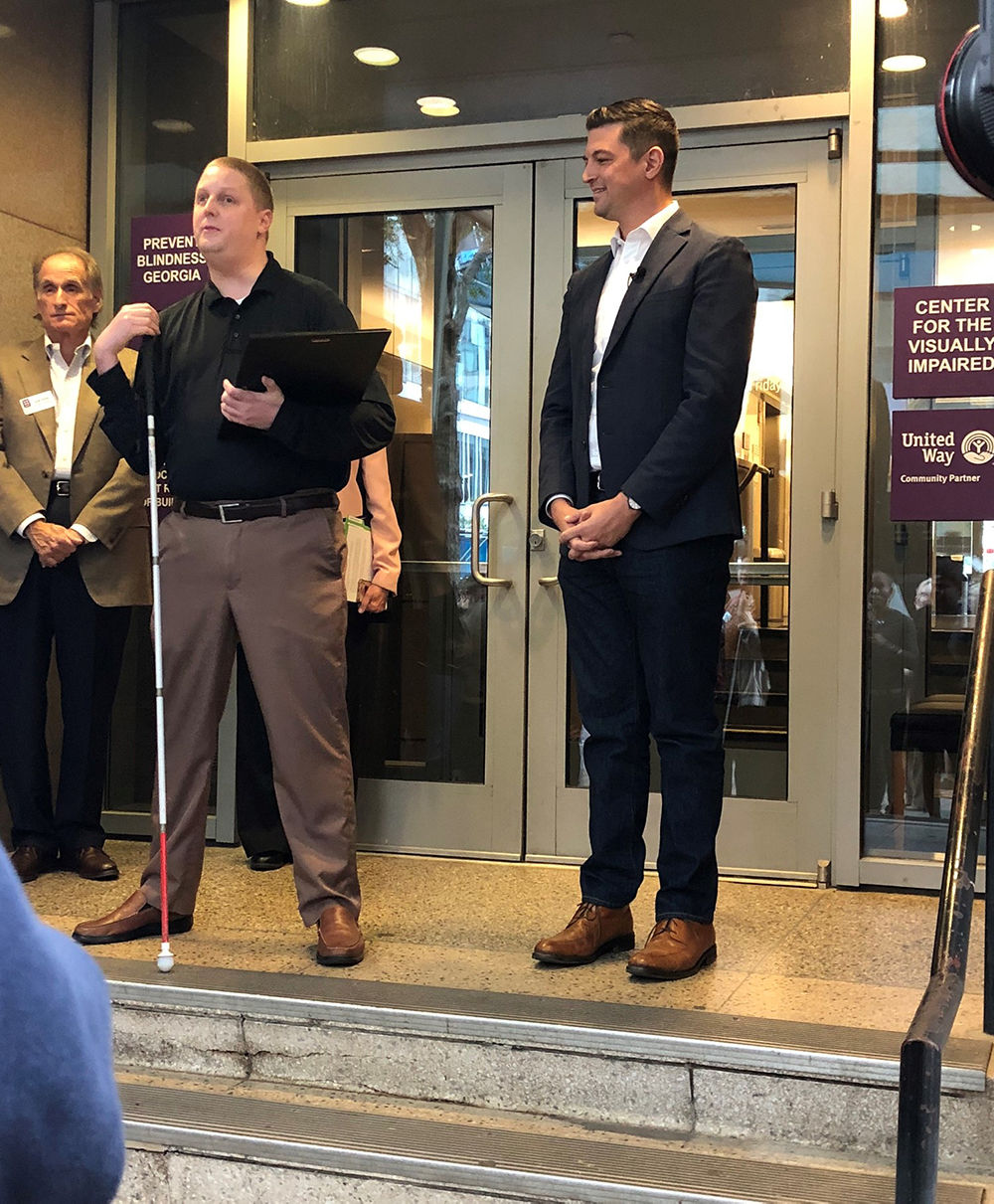 Center for the Visually Impaired former client and current employee Adam Hinchliffe introduces City Council Member Amir Farokhi in October 2019, when Farokhi issued a proclamation to declare Oct. 15 White Cane Awareness Day.